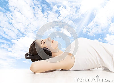 Woman in headphones dreaming listening to music. Girl relaxing Stock Photo