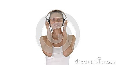 Woman with headphones listening music and making funny face on white background. Stock Photo