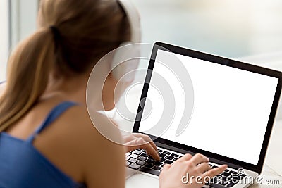 Woman in headphones looking at mock up blank screen. Stock Photo