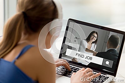 Woman in headphones looking trying to find job online. Stock Photo