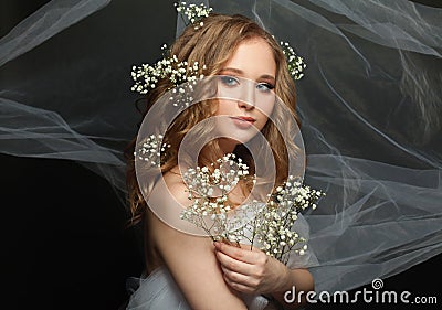 Woman with healthy blonde hair and white flowers on black background Stock Photo