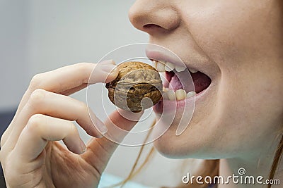 Woman with healthy tooth cracking walnut Stock Photo