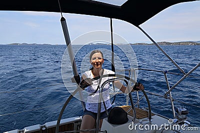 Woman at the helm of Croatia sailboat Stock Photo