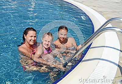Woman and her daughter have a fun in pool outdoor Stock Photo