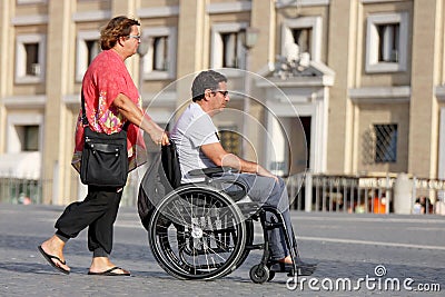 Woman and her disabled husband in the wheelchair Editorial Stock Photo