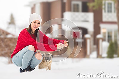 Woman with her dog on a walk outside on a winter day Stock Photo