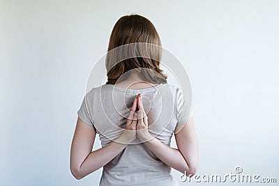 Woman with her hands laying together behind her back Stock Photo