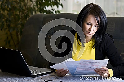 Woman and her monthly bills Stock Photo