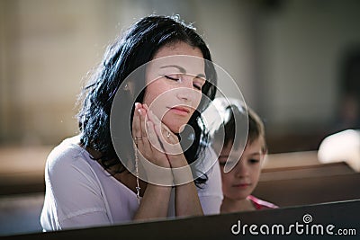 Woman with her son praying Stock Photo