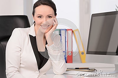 Woman at her working place. Beautiful middle-aged businesswoman Stock Photo