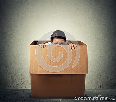 Woman hiding in a carton box Stock Photo