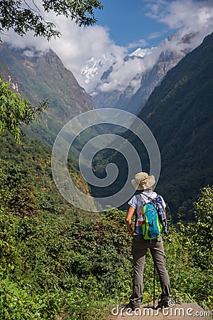 Woman hiker with backpack standing on the rock enjoy mountain view Annapurna ,Nepal. Editorial Stock Photo