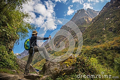 Woman hiker with backpack standing on the rock enjoy mountain view Annapurna ,Nepal. Editorial Stock Photo