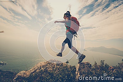 Woman hiker hiking on mountain peak Stock Photo