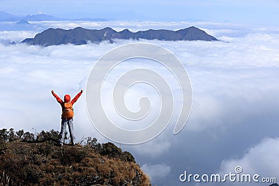 woman hiker open arms to beautiful snow mountain summits Stock Photo
