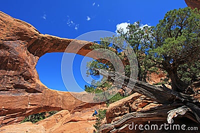 Woman hiker poses at Double O Arch at Arches National Park, Utah Stock Photo