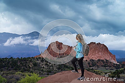 Woman hiker relaxing on top of the mountains looking at beautiful scenery. Editorial Stock Photo