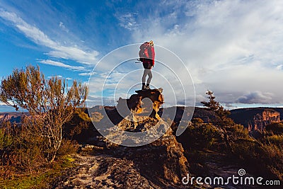 Woman hiker standing on top of rock precipice with grand views Stock Photo