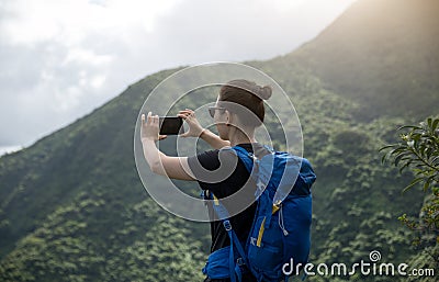 Woman hiker using smartphone Stock Photo