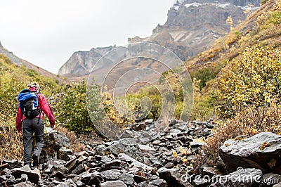 A woman hikes in the mountains of Alaska Stock Photo