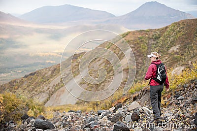 A woman hikes in the mountains of Alaska Stock Photo