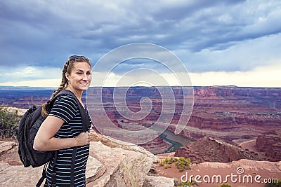 Woman hiking along a beautiful scenic canyon overlook Stock Photo