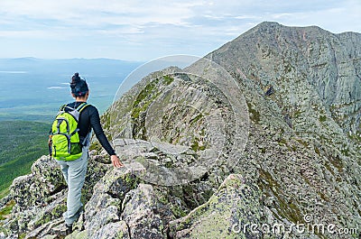 Woman hiking along Knife Edge Trail of Mount Katahdin Northeast Piscataquis Maine USA Stock Photo