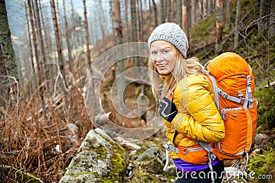 Woman hiking in autumn forest trail Stock Photo