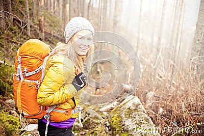 Woman hiking in autumn forest trail Stock Photo