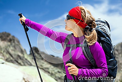 Woman hiking with backpack in mountains Stock Photo