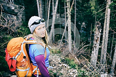 Woman hiking in winter cold dark winter forest Stock Photo