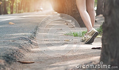 Woman hitchhiker walking on highway road Stock Photo
