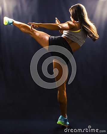 Woman hitting with a high kick Stock Photo