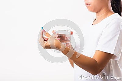 Woman hold pill drugs in hand ready take medicines with a glass of water Stock Photo