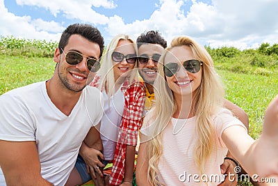 Woman hold smart phone camera taking selfie photo friends face close up picnic countryside Stock Photo