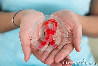 Woman Holding Aids Awareness Ribbon Stock Photo