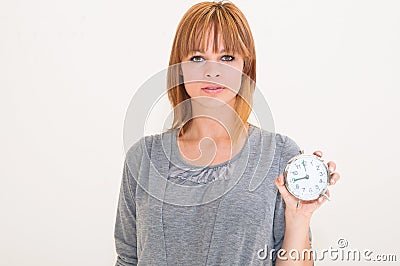 Woman holding alarm clock Stock Photo