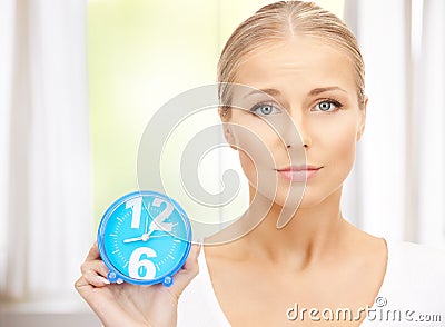 Woman holding alarm clock Stock Photo