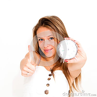 Woman holding alarm clock with thumbs up Stock Photo