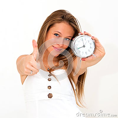 Woman holding alarm clock with thumbs up Stock Photo