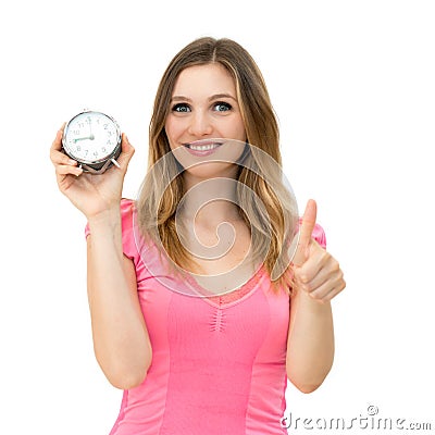 Woman holding alarm clock with thumbs up Stock Photo