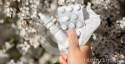 Woman holding allergy pills, drugs and nose spray against kind of an allergies during spring time, helathcare concept Stock Photo