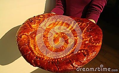 Woman Holding a Beautiful Decorated Large Gata, Tasty Sweet Filled Armenian Traditional Bread Stock Photo