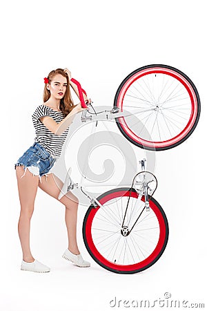 Woman holding bicycle up Stock Photo