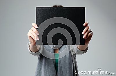 Woman holding a book and showing blank black cover Stock Photo