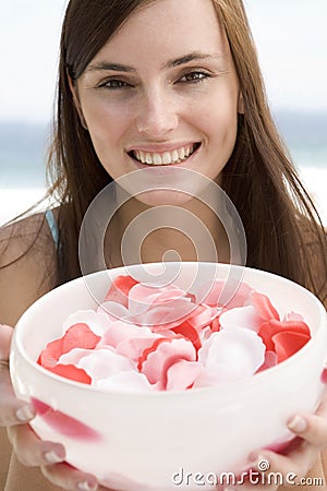 Woman holding bowl of petals Stock Photo