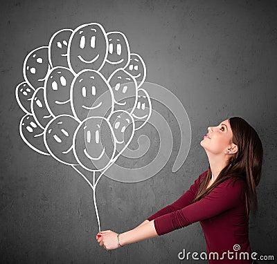 Woman holding a bunch of smiling balloons Stock Photo