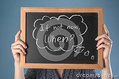 Woman holding chalkboard with phrase If not now. When? on color background. Time management concept Stock Photo