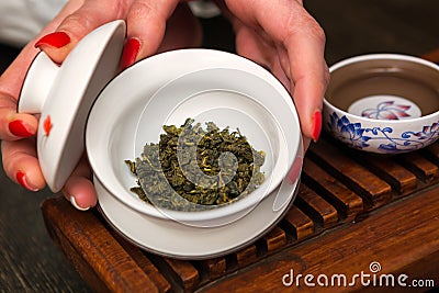 Woman holding chawan with green oolong. Stock Photo