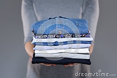 Woman holding clothes in hands Stock Photo